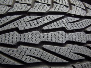 Close up of winter tires with sipes in the treads 